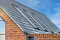 A wonderful example of how perfectly flush Clement Conservation Rooflights look when fitted into a slate roof.